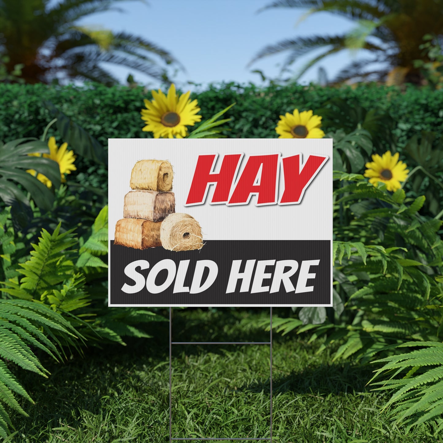 Hay sold here sign in a garden setting with greenery and flowers.