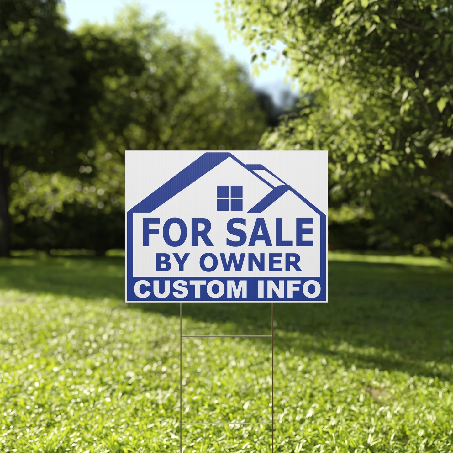 For Sale by Owner sign on a grassy lawn with trees in the background
