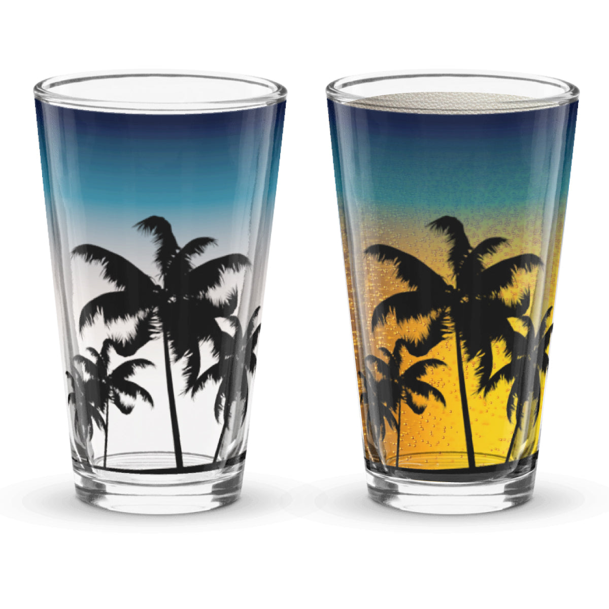 Two glasses with palm tree design, sunset background when beer is poured into the glass.
