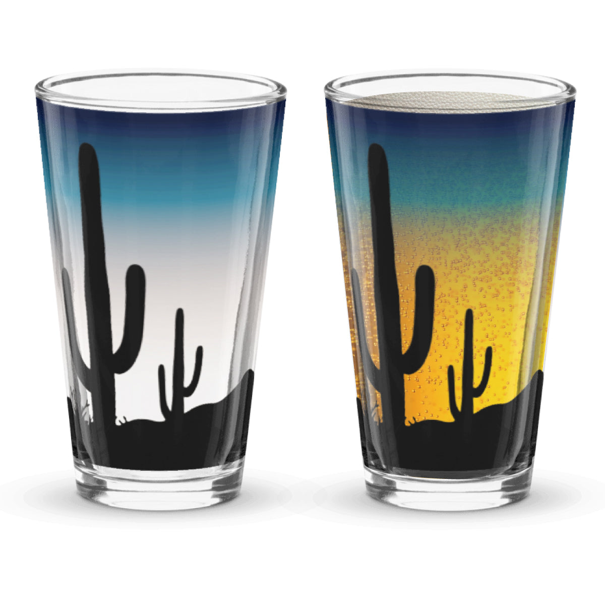 Two glass tumblers with desert landscape design featuring cacti. Sunset background when beer is poured into the glass.