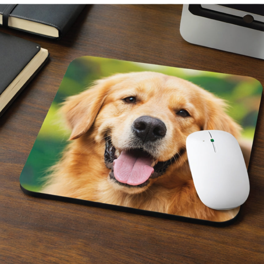 Mouse pad with a golden retriever design on a wooden surface with a white mouse.