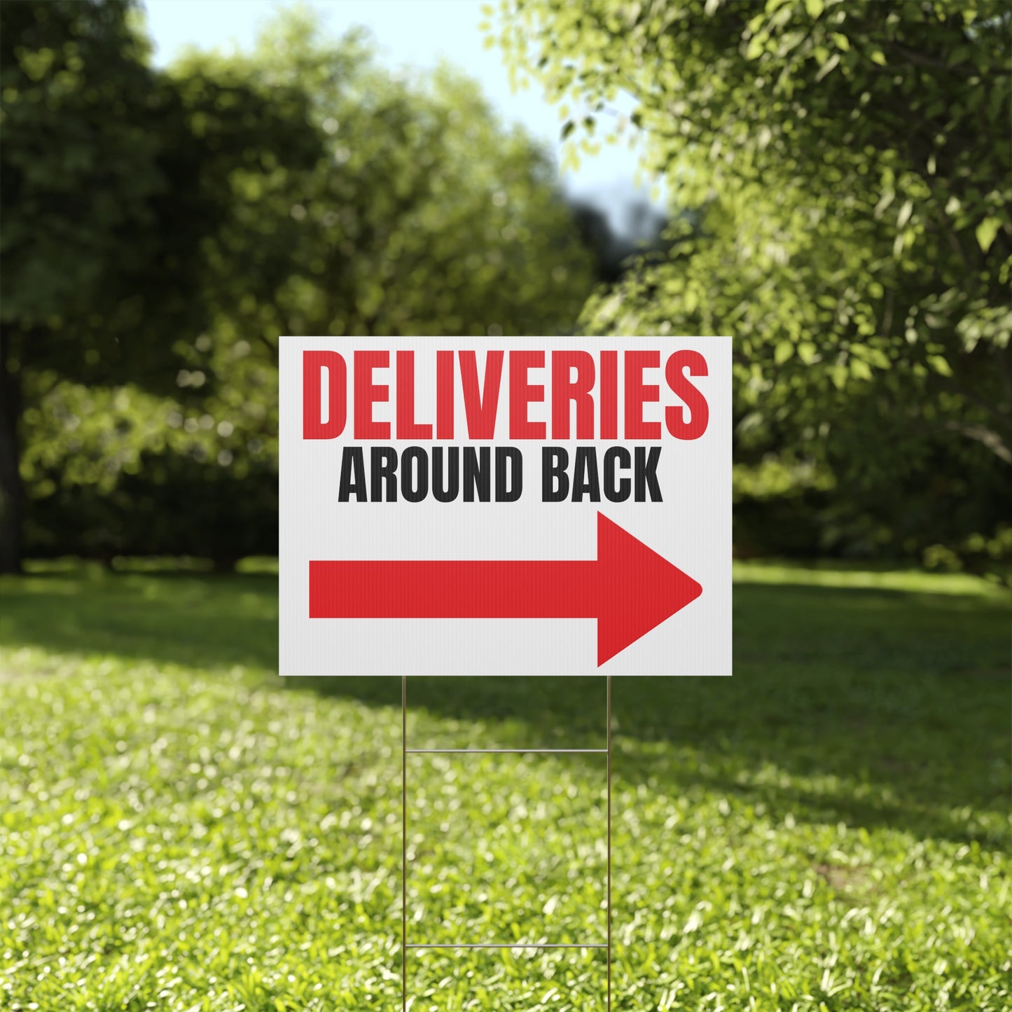 Garden sign with 'DELIVERIES AROUND BACK' text and red arrow on grass