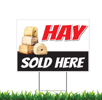 A double-sided 'Hay Sold Here' yard sign with a stack of hay on the front and text on a red and white background.
