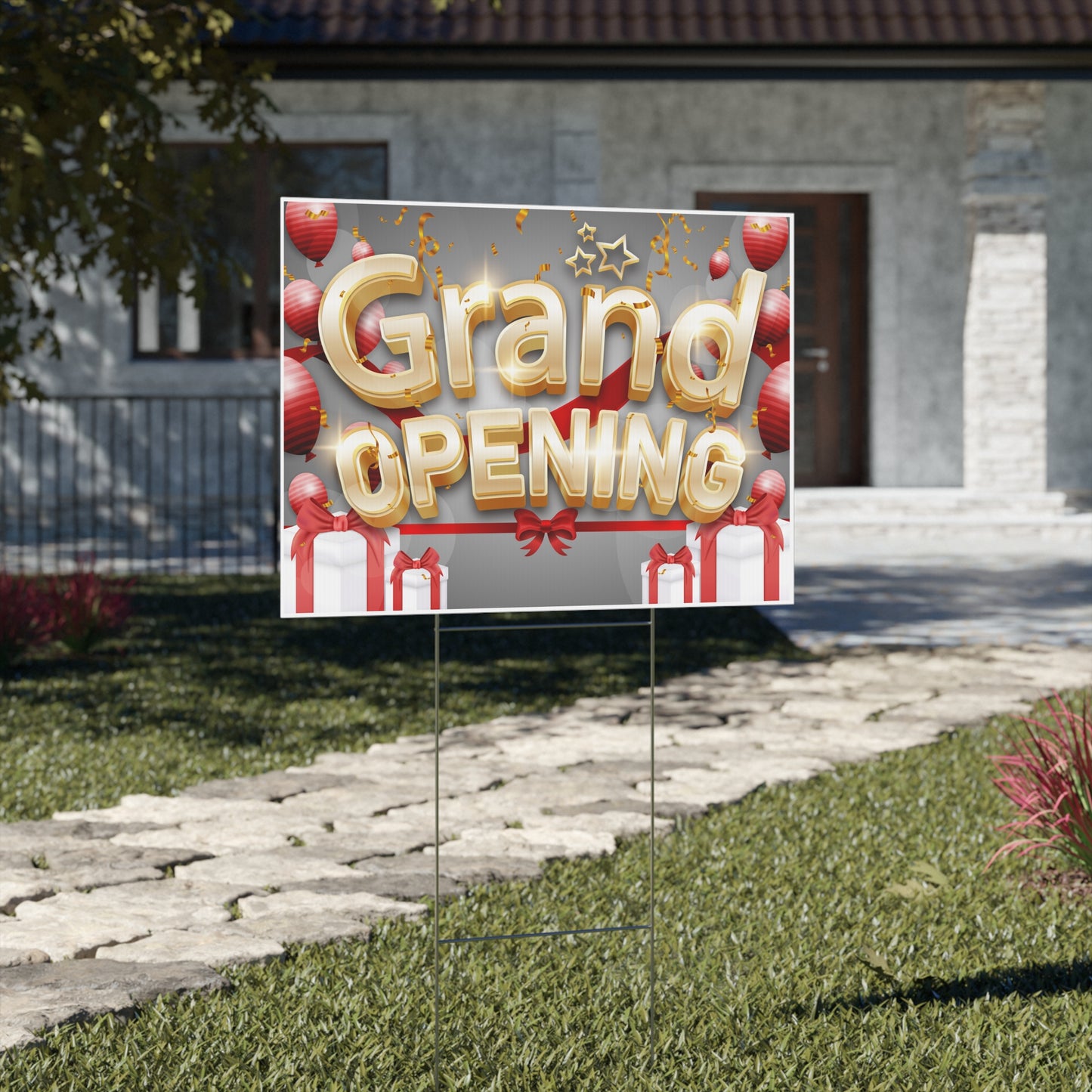 Grand opening square yard sign with balloons and presents on a grassy lawn in front of a house.